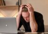 Mann sitzt verzweifelt am Schreibtisch, weil er Opfer eines Cyberangriffs wurde